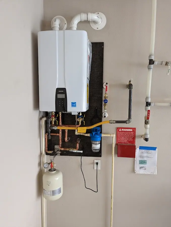 Professional plumber installing copper piping in a Leicester home